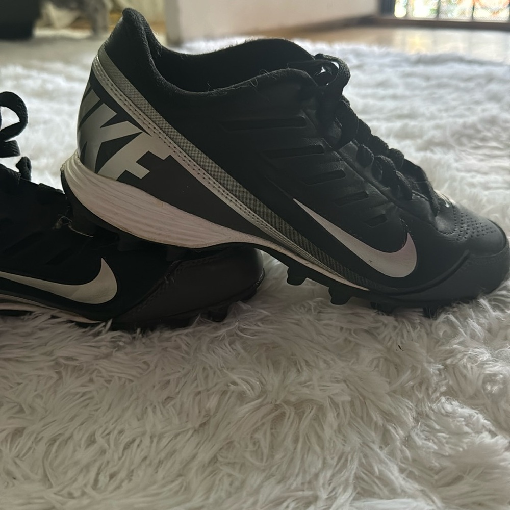 Black, white and grey Land Shark Nike cleats.